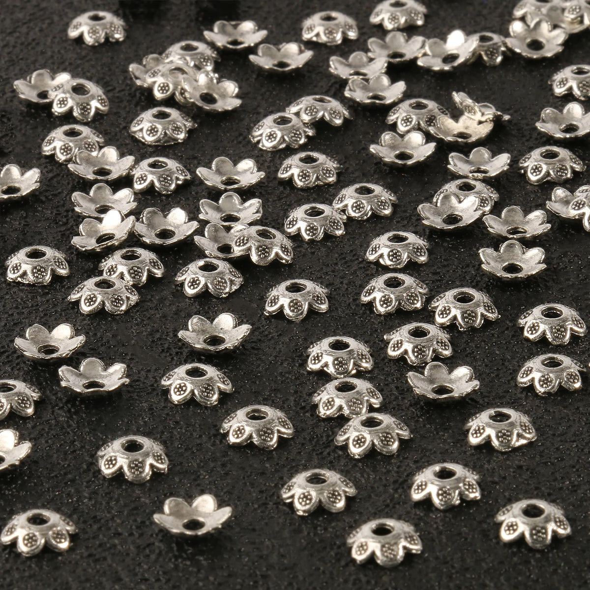 Small silver hollow flower bead caps used for jewelry making