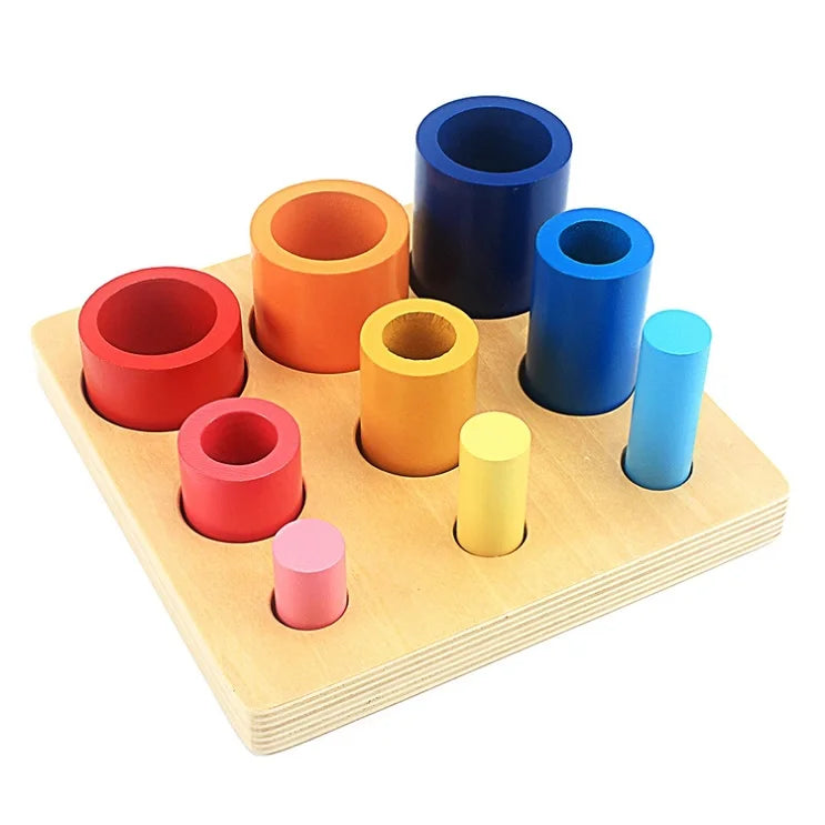 A set of colorful wooden Montessori sensory cups in various shades of blue, orange, and red arranged on a light wooden board.
