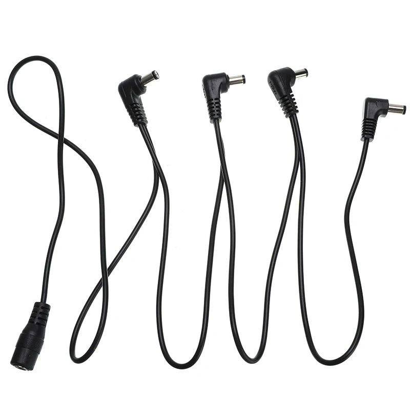 A set of black guitar pedal power daisy chain cables with various connectors.