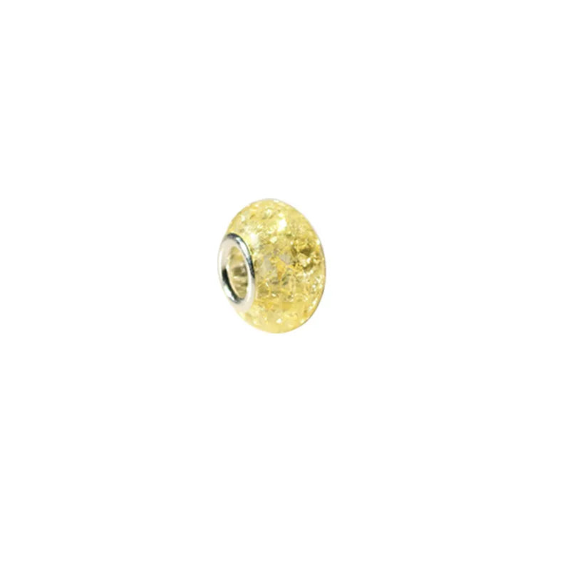 A single yellow resin spacer bead with a silver-colored metal cap.