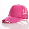 A bright pink trucker hat with a mesh back and a curved brim is shown against a white background.