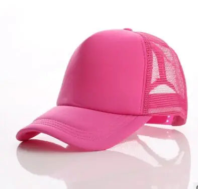 A bright pink trucker hat with a mesh back and a curved brim is shown against a white background.
