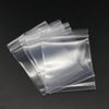 A stack of clear resealable plastic bags for jewelry and small item storage.