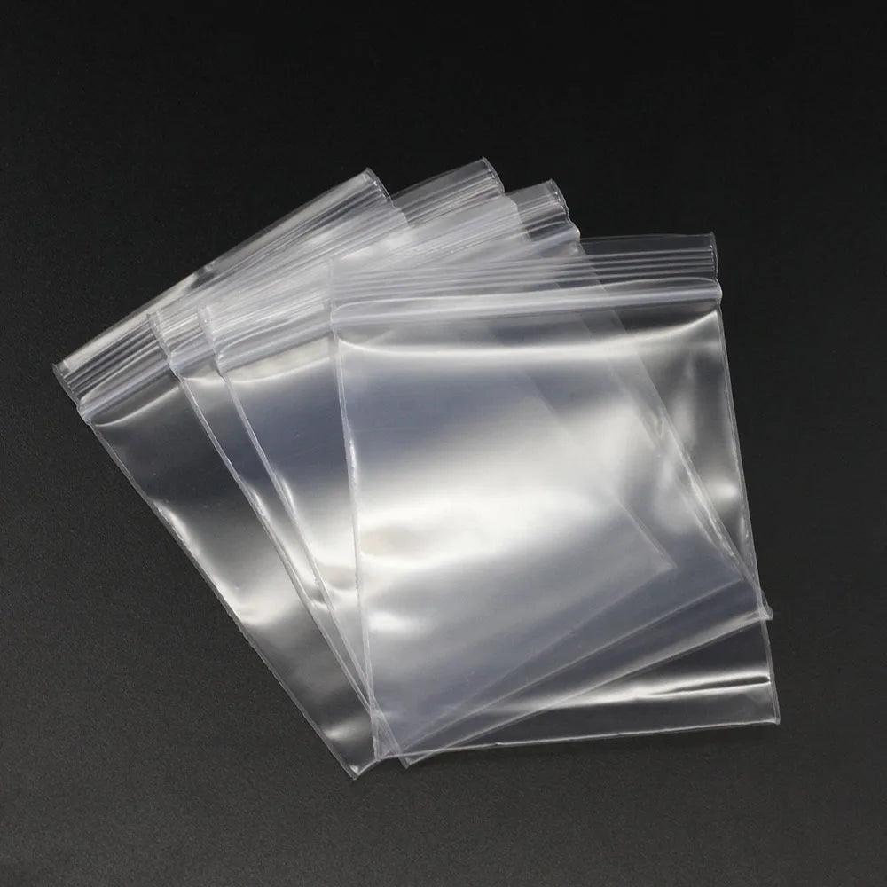 A stack of clear resealable plastic bags for jewelry and small item storage.