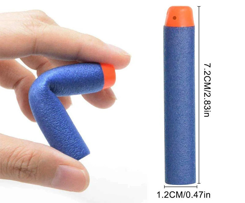 A hand holds a blue foam dart refill with an orange tip, next to a measuring scale showing its dimensions.