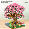 A detailed LEGO set depicting a pink flowering tree house with wooden structures and greenery.
