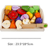 A wooden magnetic fruit and vegetable cutting play set with various colored, shaped pieces in a light wooden tray.