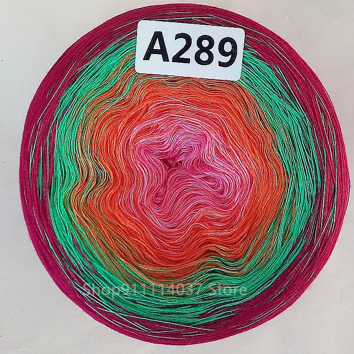 A spool of rainbow gradient mercerized cotton cake yarn labeled A289