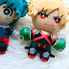 Two My Hero Academia plush figures, one with teal hair and another with blonde hair, are displayed on a white fluffy surface.