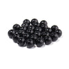 A pile of small, dark, spherical imitation pearl beads for DIY jewelry making.