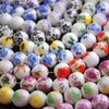 A collection of colorful floral ceramic beads in various shades of white, purple, and green for jewelry making.