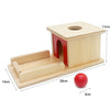 A wooden Montessori sensory toy set featuring a small house structure and a red ball.