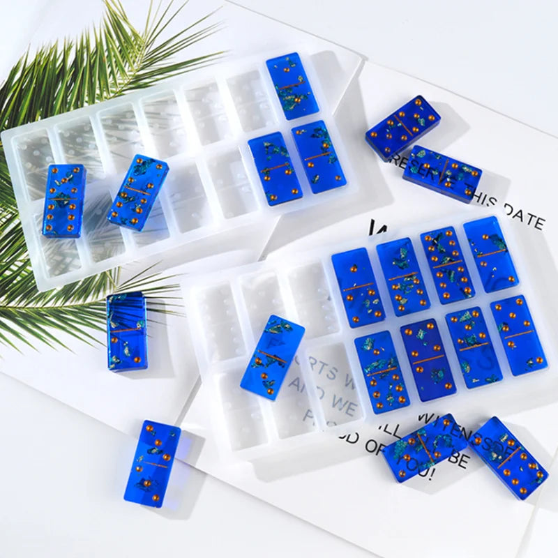 A silicone mold set for domino-shaped epoxy resin jewelry making with various blue and yellow designs.