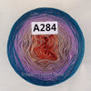 A ball of A284 cake yarn showing a vibrant rainbow gradient of colors.