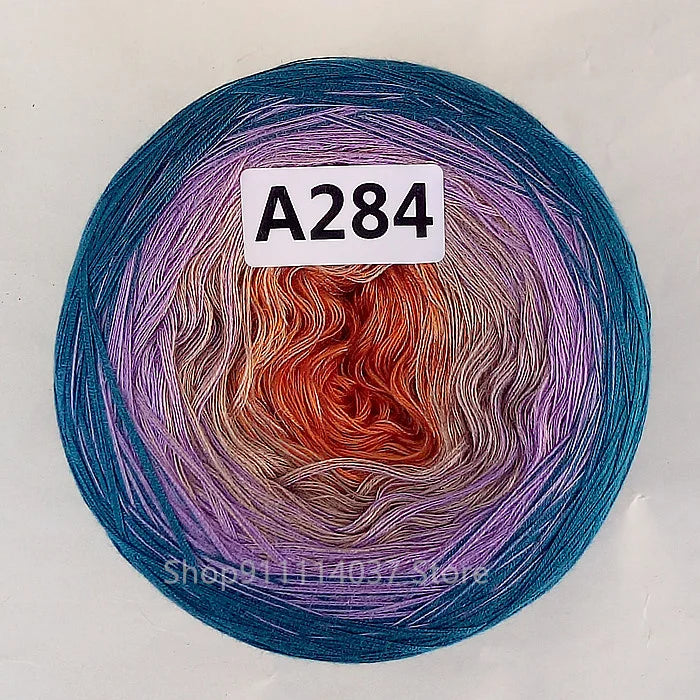 A ball of A284 cake yarn showing a vibrant rainbow gradient of colors.
