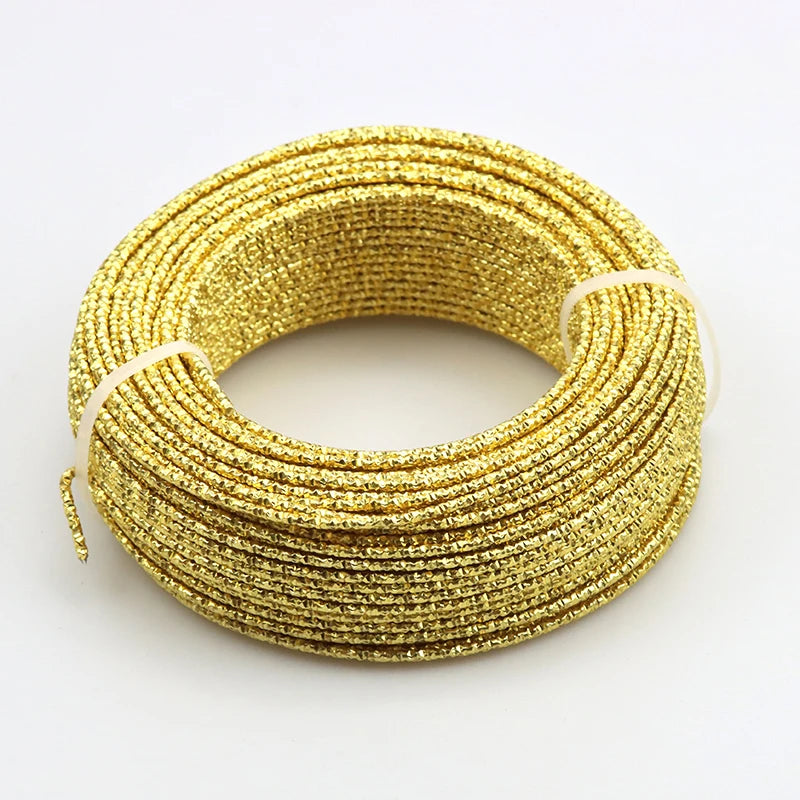 A coil of flexible gold glitter wire used for jewelry making and DIY projects.