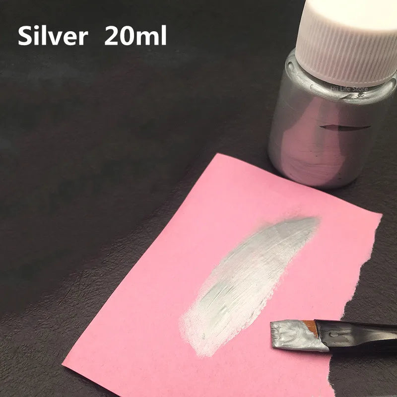 Silver 20ml bottle of metallic silver acrylic paint next to a swatch on pink paper