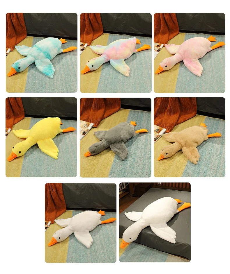 A collection of oversized kawaii goose plush pillows in various colors including blue, pink, yellow, gray, and white.