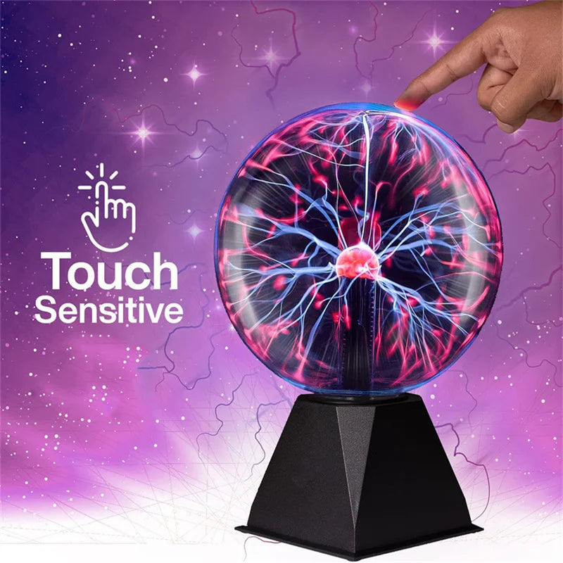 A hand touches a glowing, spherical plasma ball lamp that emits bright blue and pink electrical arcs against a purple backgro