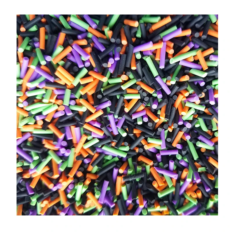 A close-up view of colorful soft polymer clay candy sprinkles in various shapes and colors for cake decorating.