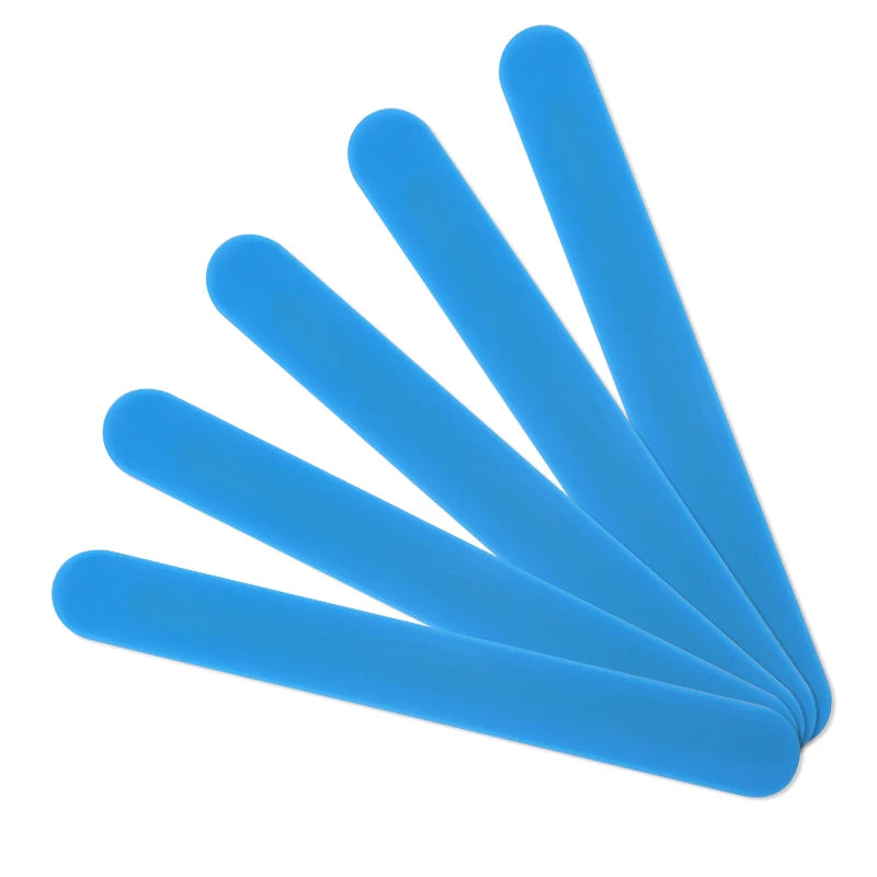 Five blue silicone stir sticks arranged diagonally on a white background.