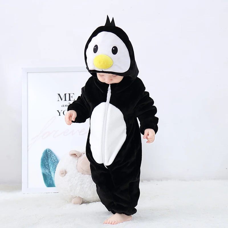 A baby wearing an adorable animal hooded romper resembling a penguin, featuring black and white fur textures.