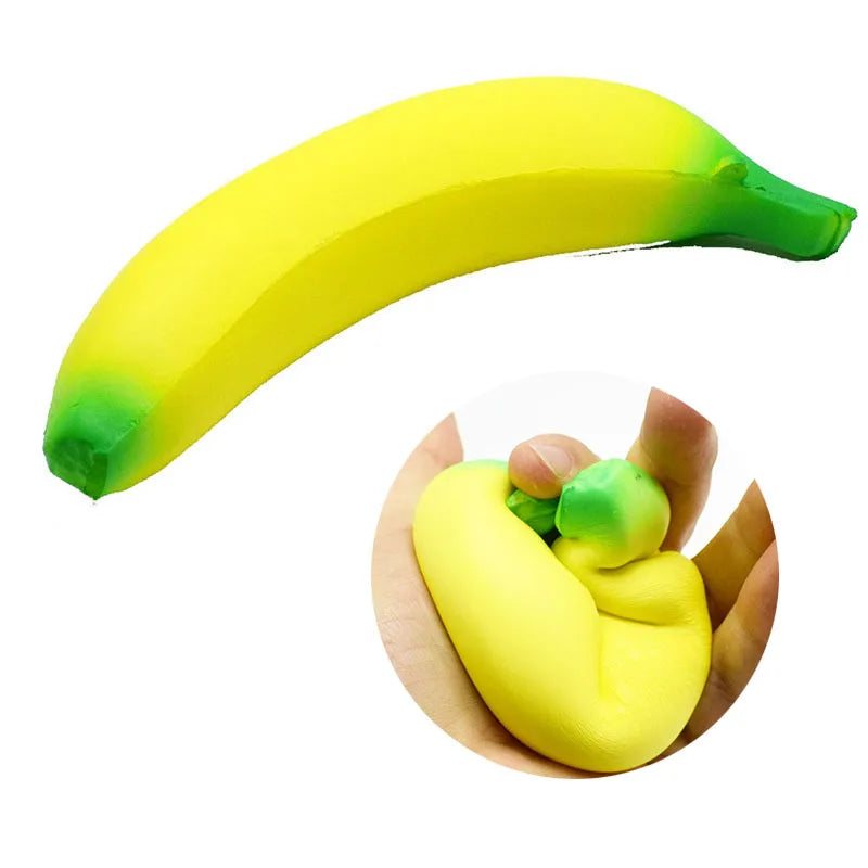 A bright yellow banana stress reliever toy with green accents, shown in a curved shape.
