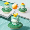 A set of three green frog bath toys with yellow heads and an orange sphere, featuring a floating water sprinkler design.
