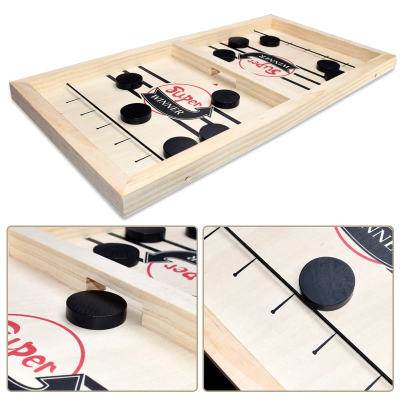 A wooden sling puck game board with black pucks and a winner marker, shown from an overhead angle.