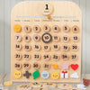 A wooden cognitive calendar showing January dates, weather icons, and activity markers for learning.