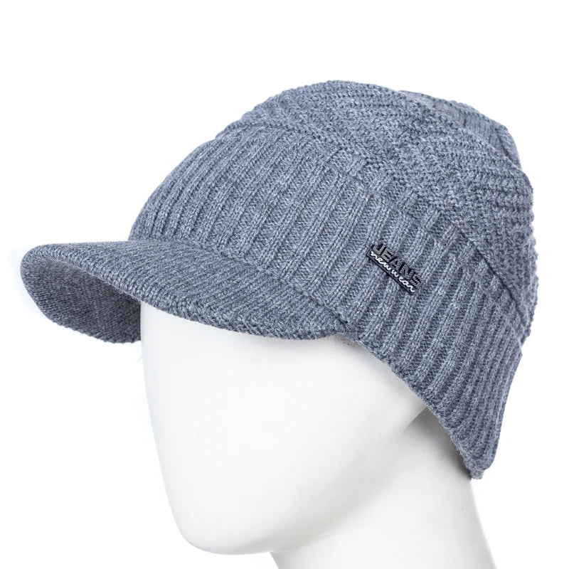 A gray knit beanie with a brim is displayed on a mannequin.