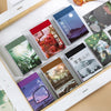 A collection of aesthetic landscape stickers in a booklet featuring nature and art designs for scrapbooking
