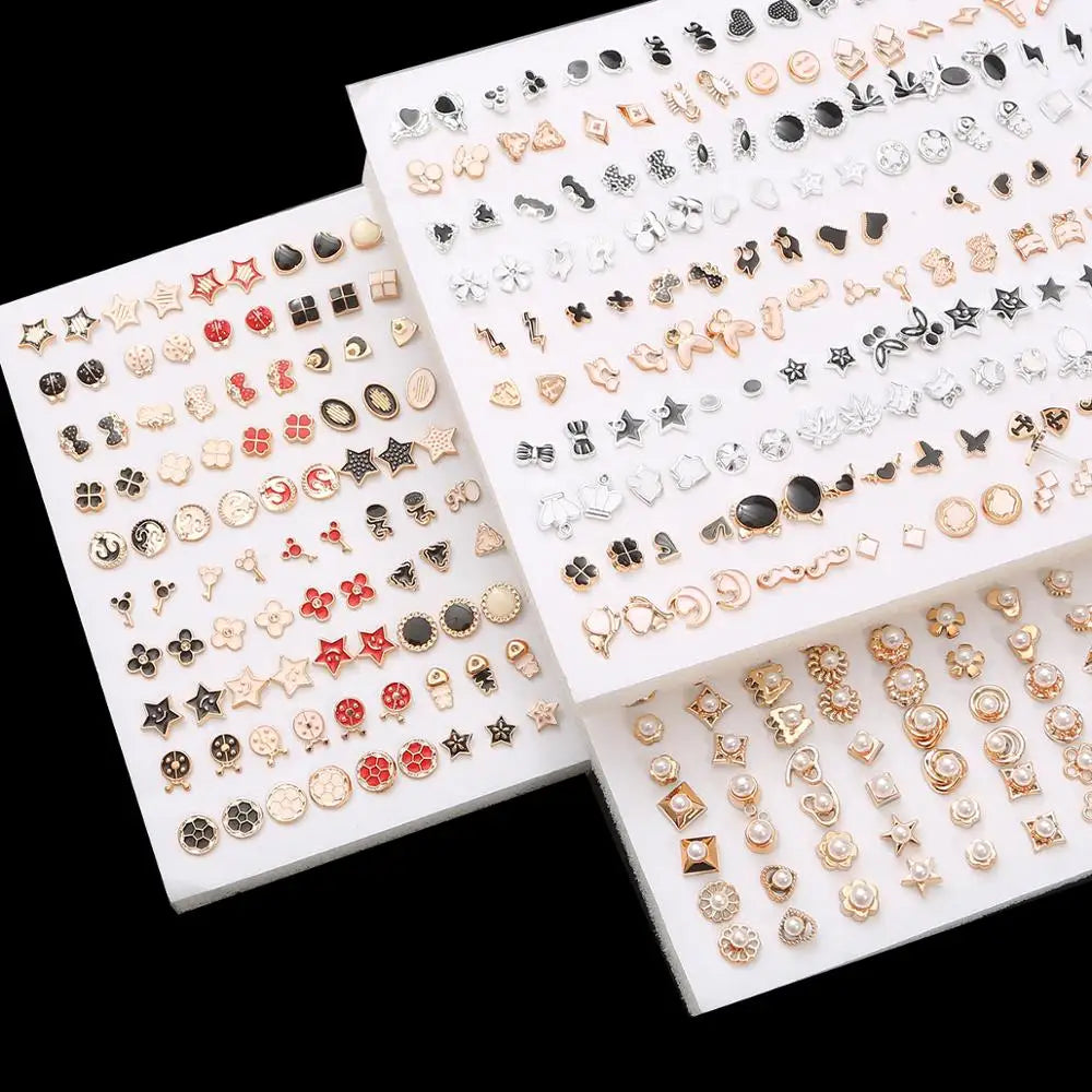 A collection of assorted acrylic stud earrings featuring hearts, stars, and moons in various gold and silver tones.
