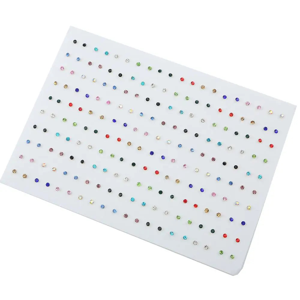 A white display card showing 100 pairs of assorted acrylic stud earrings including hearts, stars, and moons.