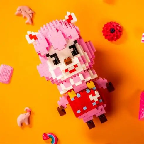 A pink and yellow building block figure resembling a stylized animal character is displayed on an orange background.