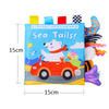 A colorful cloth book featuring a polar bear driving a red car with sea tails for baby sensory play.