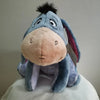 A soft blue Eeyore plush toy resembling a donkey with pink accents.