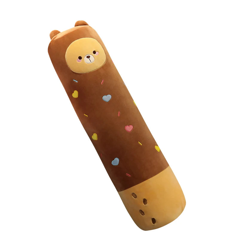 A brown long body stuffed animal plush pillow with a light yellow face and colorful confetti spots.