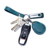 A vintage cowhide leather key wallet featuring a card holder and attached keys on a dark green leather strap.
