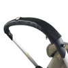 A black leather stroller accessory kit featuring a mosquito net and rain cover attached to a white pole.