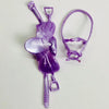 A purple 1/12 scale dollhouse horse saddle and riding prop accessory.