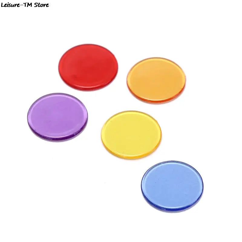 A collection of five colorful plastic bingo chips in red, orange, purple, yellow, and blue.