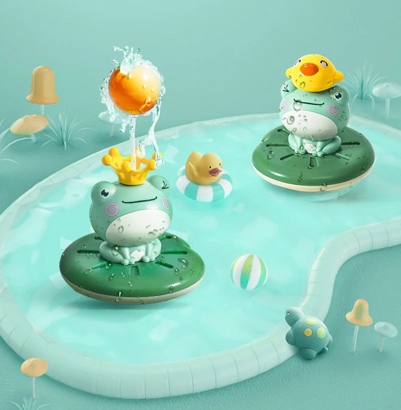 A green frog bath toy with a yellow head and other aquatic toys floating in light blue water.