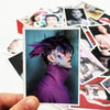A close-up photo of a person with purple hair and face paint wearing a purple turtleneck, displayed on a white card.