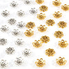A collection of silver and gold Tibetan style hollow flower bead caps for jewelry making.