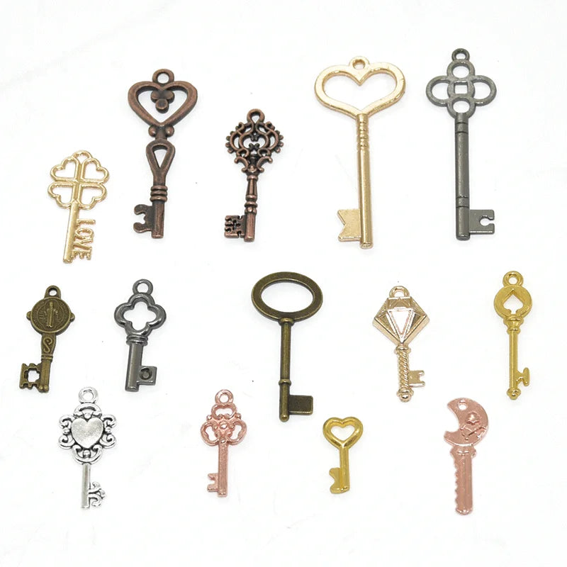 A collection of vintage metal key charms in various styles and finishes for DIY jewelry making