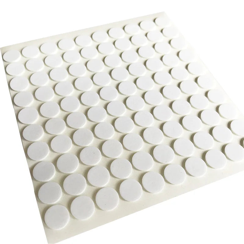 A white silicone mat with small, round, heat-resistant double-sided stickers arranged in a grid.