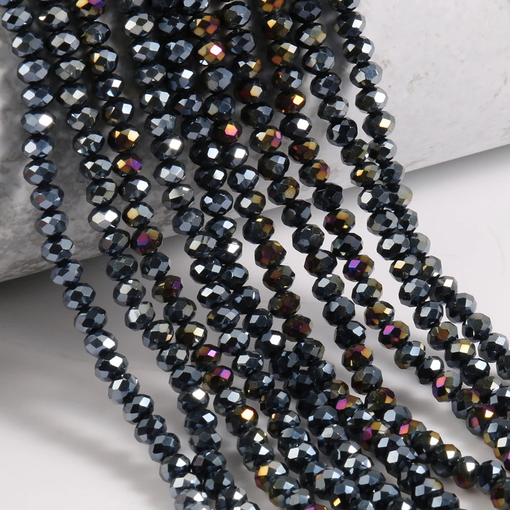 Dark blue faceted crystal glass beads strung on threads for jewelry making