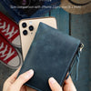 A hand holds a dark blue leather coin purse with a zipper, next to an iPhone 11 Pro Max for size comparison.