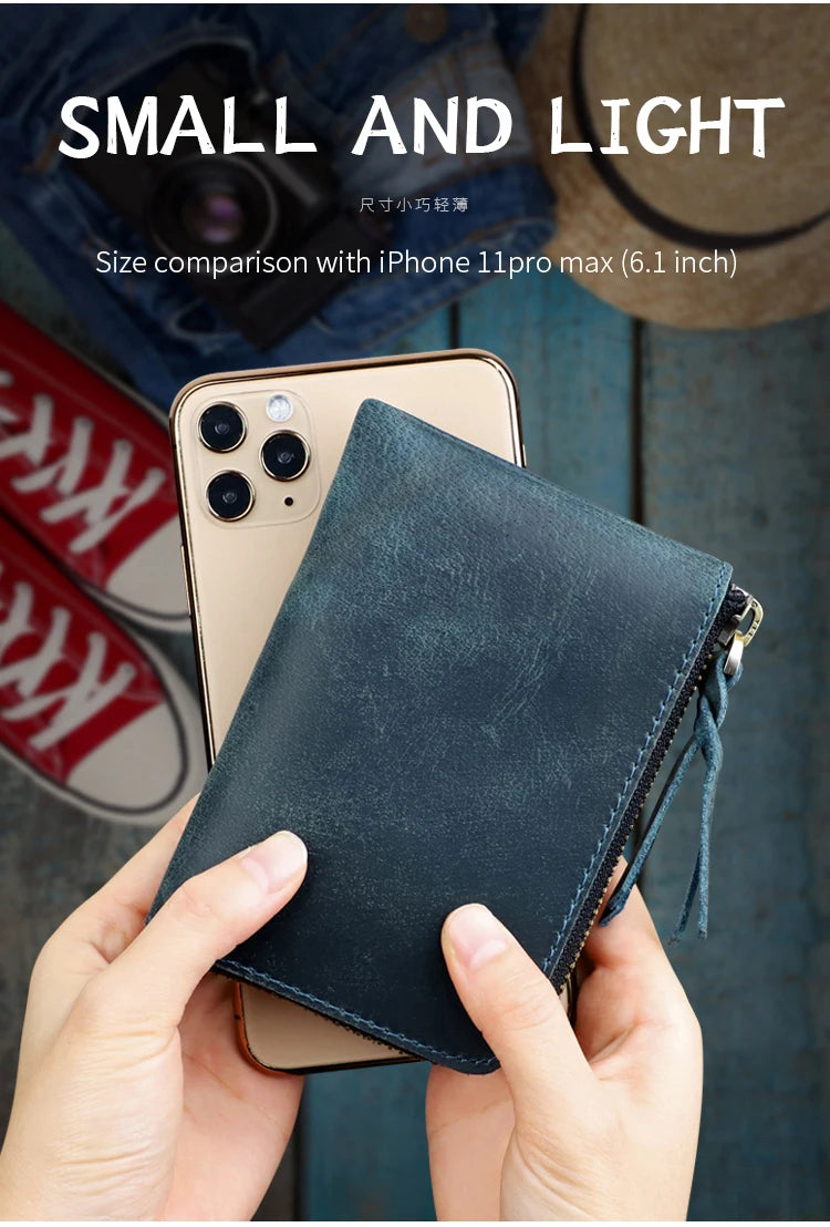 A hand holds a dark blue leather coin purse with a zipper, next to an iPhone 11 Pro Max for size comparison.